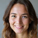 A smiling woman in her 30s, looking healthy and vibrant.